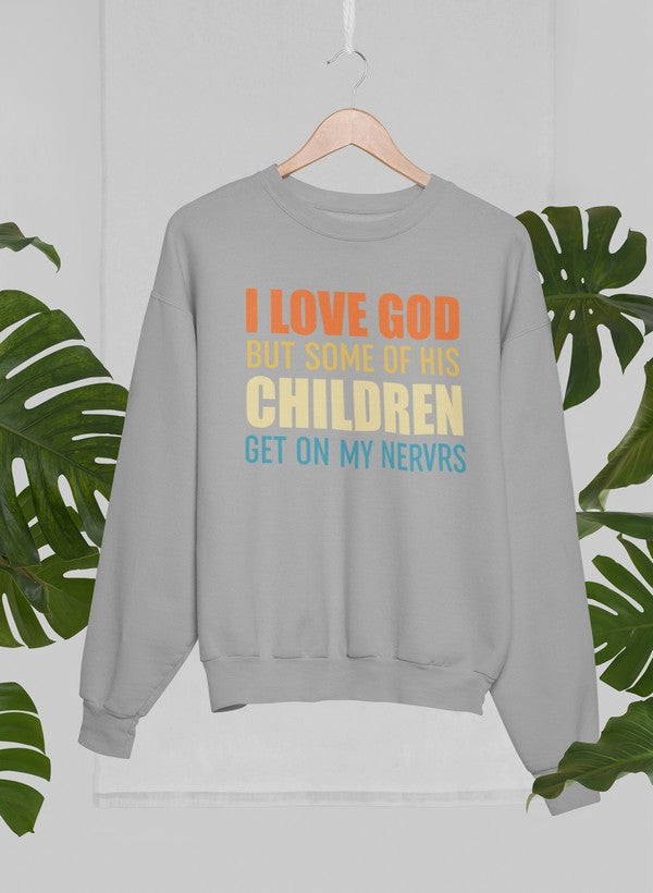 Gray sweatshirt with colorful text on a hanger against a light gray background with green leaves.