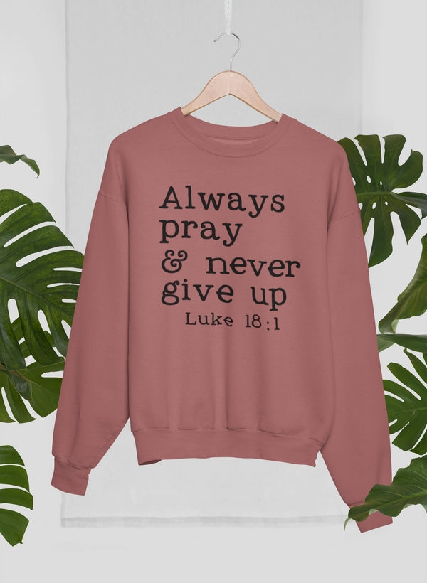 Mauve sweatshirt with motivational text on a white background with green leaves.