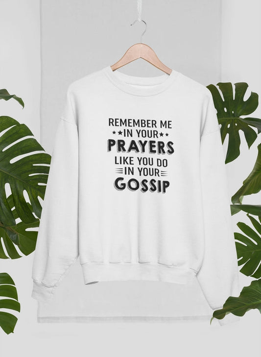 White sweatshirt with text on a hanger against a white background with green leaves.