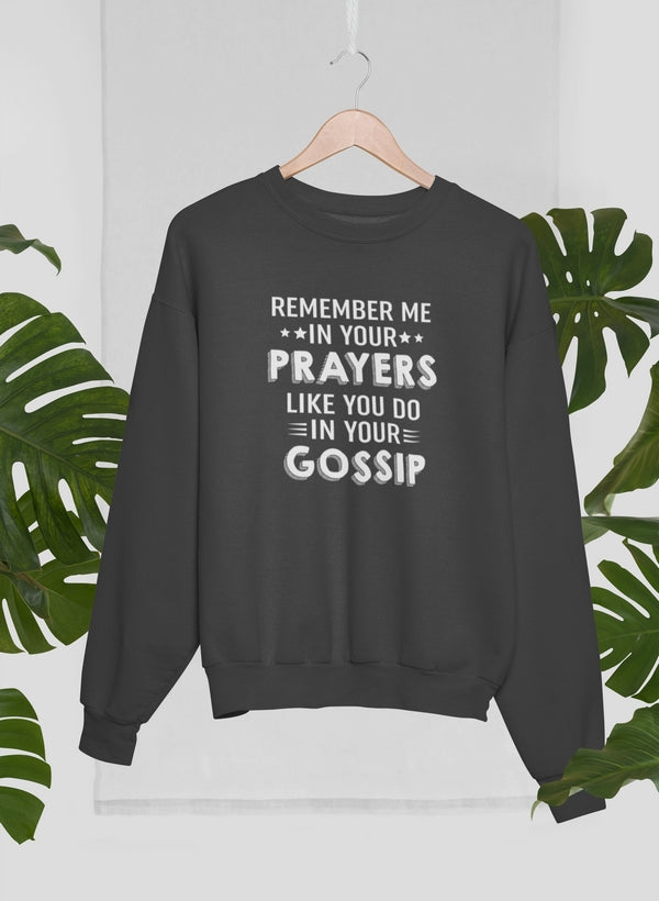 Black sweatshirt with humorous text design on a hanger against a white background with green leaves.