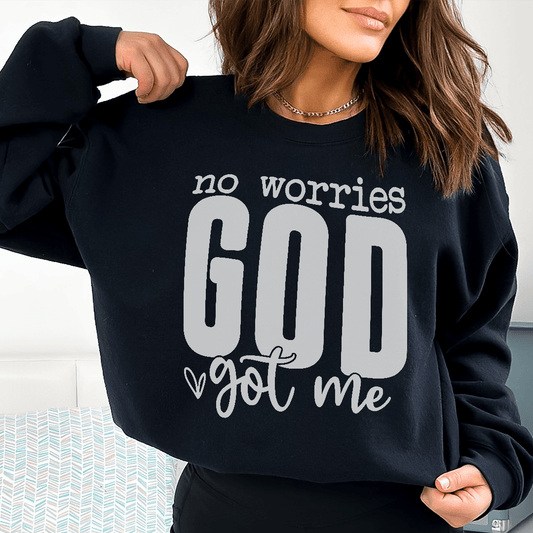 Person wearing a black sweatshirt with 'no worries GOD got me' text